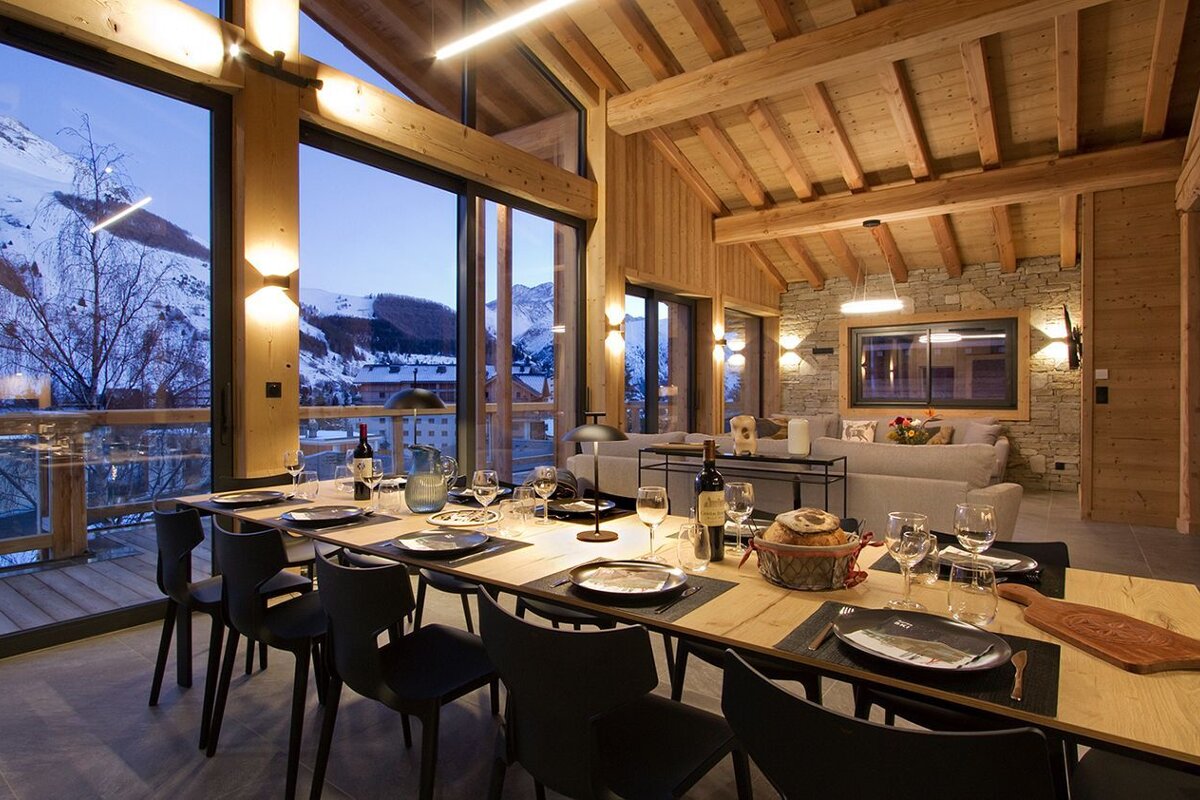 A dining room table with a basket of bread on it