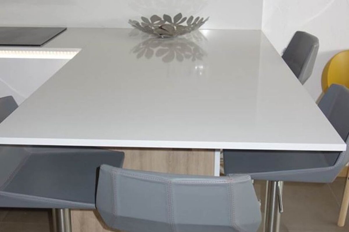 A white table with a bowl on top of it