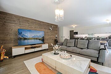 A living room with a couch and a flat screen tv