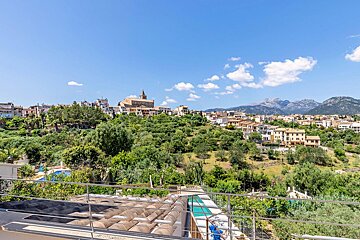 A view of a small town with mountains in the background