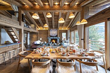 A dining room table with plates of food on it
