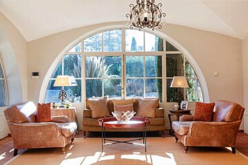 A living room with a couch and two chairs