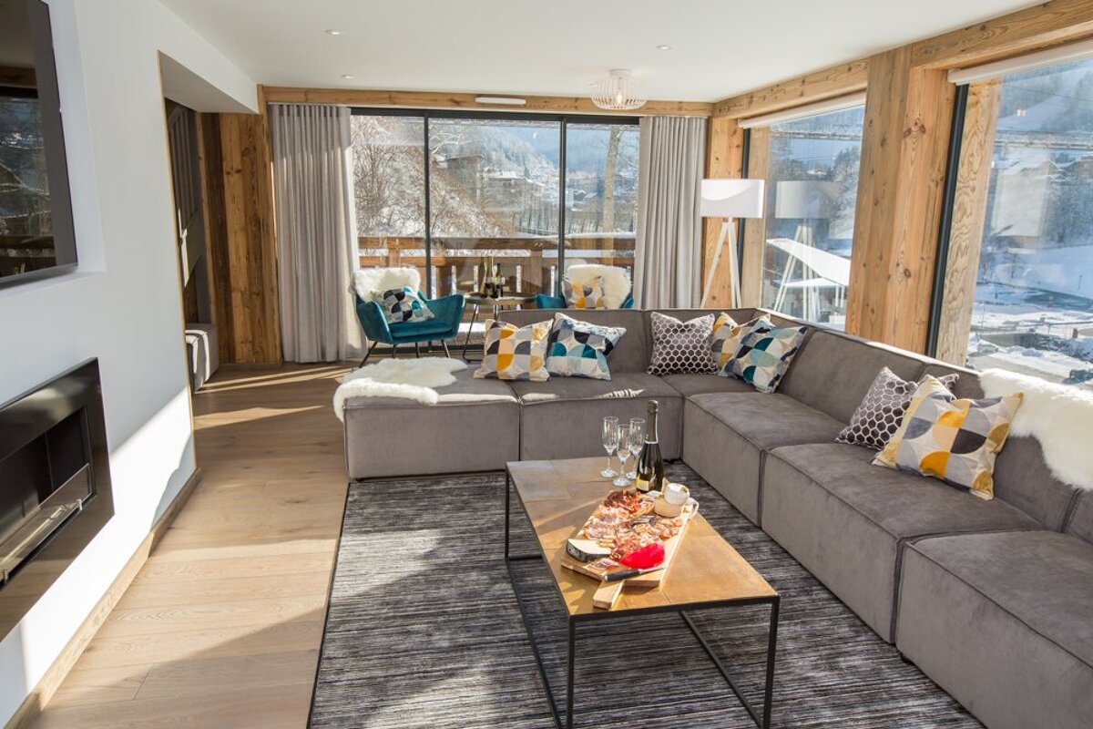 A living room with a large sectional couch and a coffee table