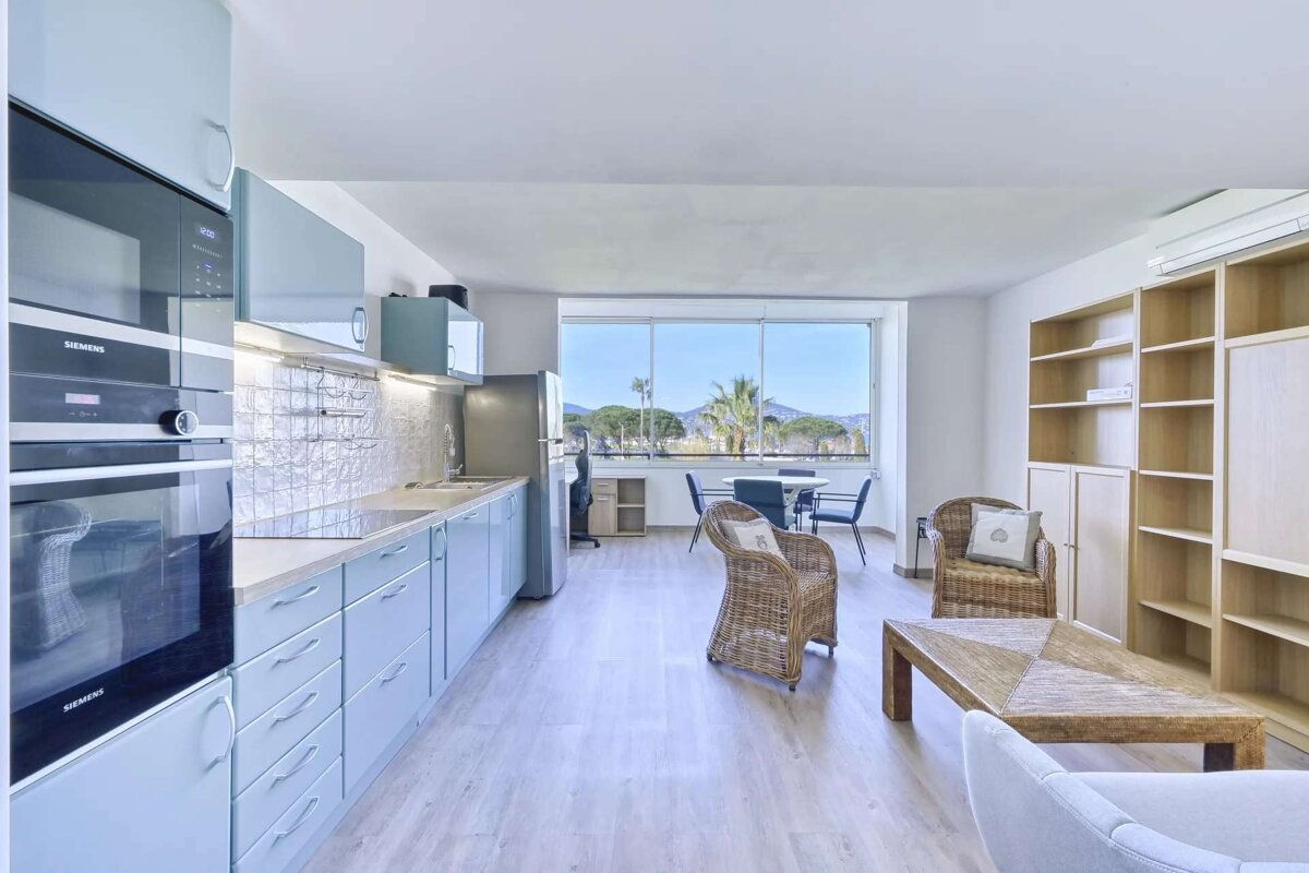 A kitchen with blue cabinets and a siemens oven