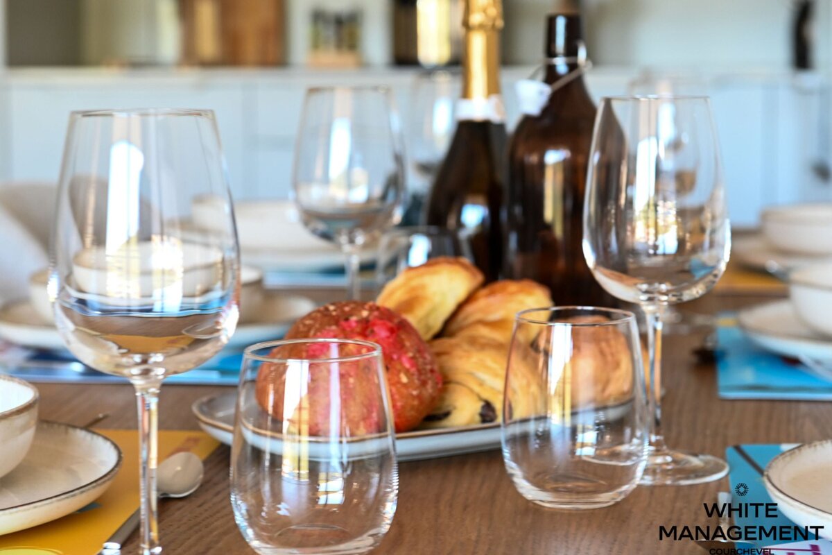 A table set for a meal with a rental designer logo in the corner