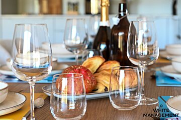 A table set for a meal with a rental designer logo in the corner