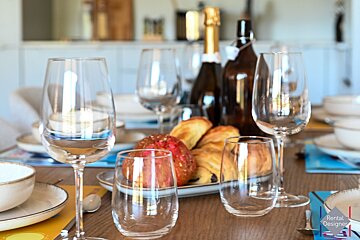 A table set for a meal with a rental designer logo in the corner