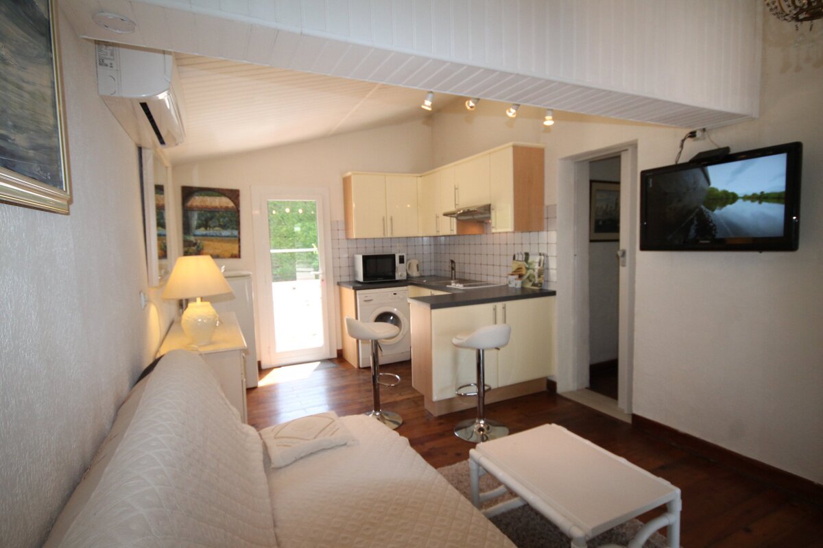 A living room with a couch and a flat screen tv