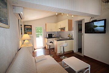 A living room with a couch and a flat screen tv