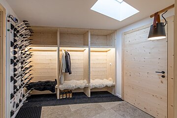 A wooden hallway with a skylight above the door