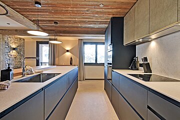 A kitchen with a sink and a stove top oven