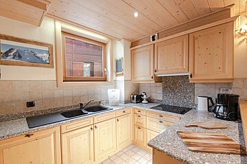 A kitchen with wooden cabinets and granite counter tops