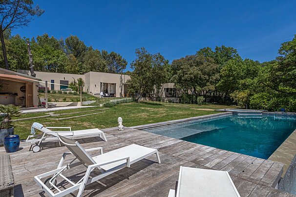 A large swimming pool in the backyard of a house