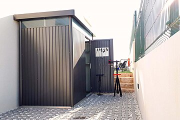A shed with a sign on the door that says ' a ' on it