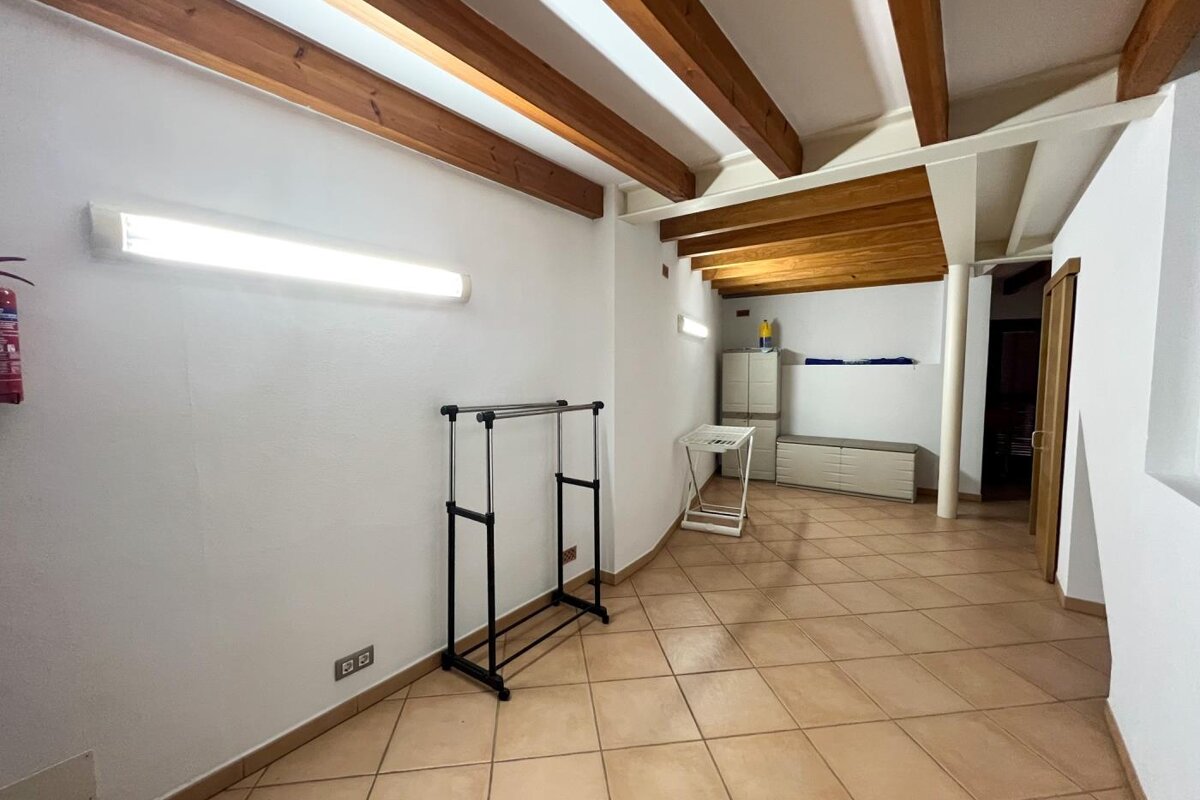 An empty hallway with a fire extinguisher on the wall