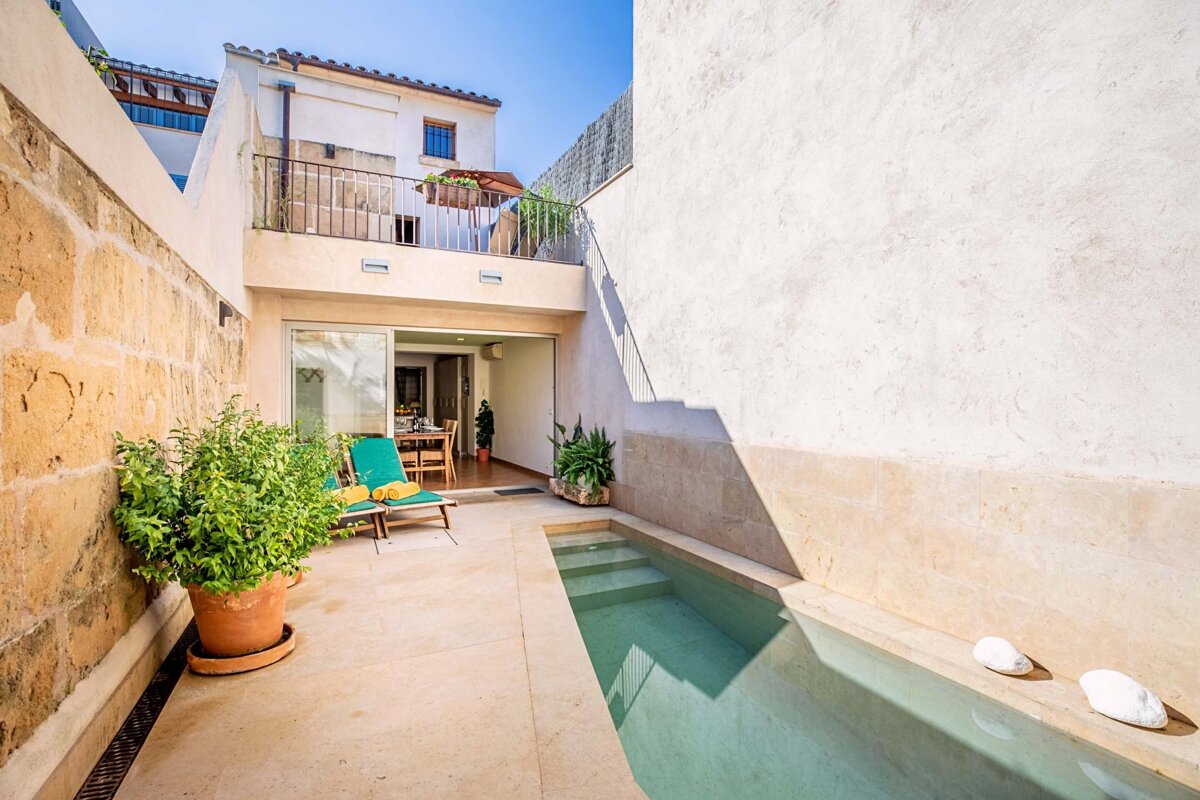 A small swimming pool in the backyard of a house