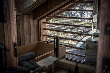 A bathroom with a wooden tub and a window