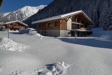 A snowy landscape with a mountain in the background