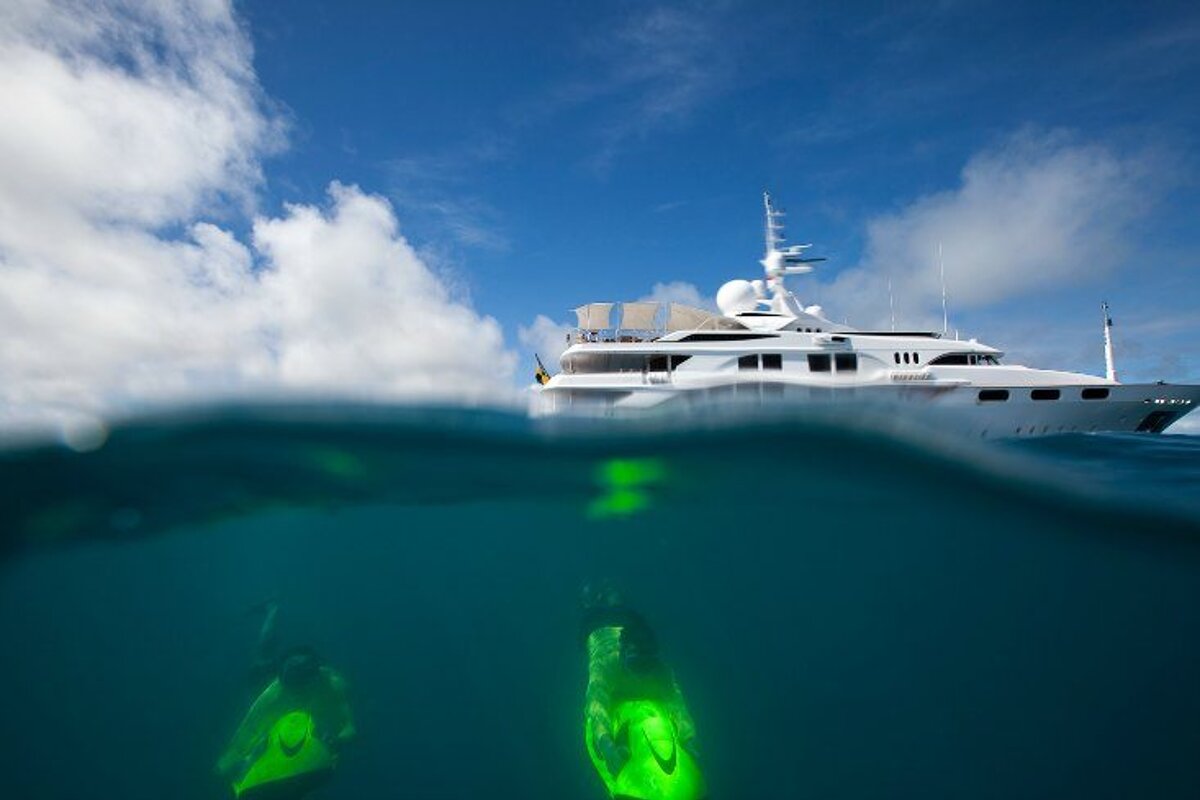 A large white yacht is floating on top of a body of water