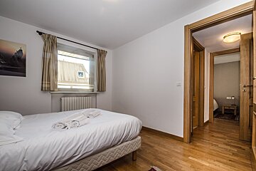 A bedroom with a single bed and a window