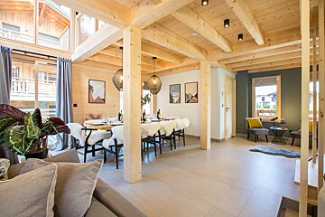 A wooden house with a dining table and chairs