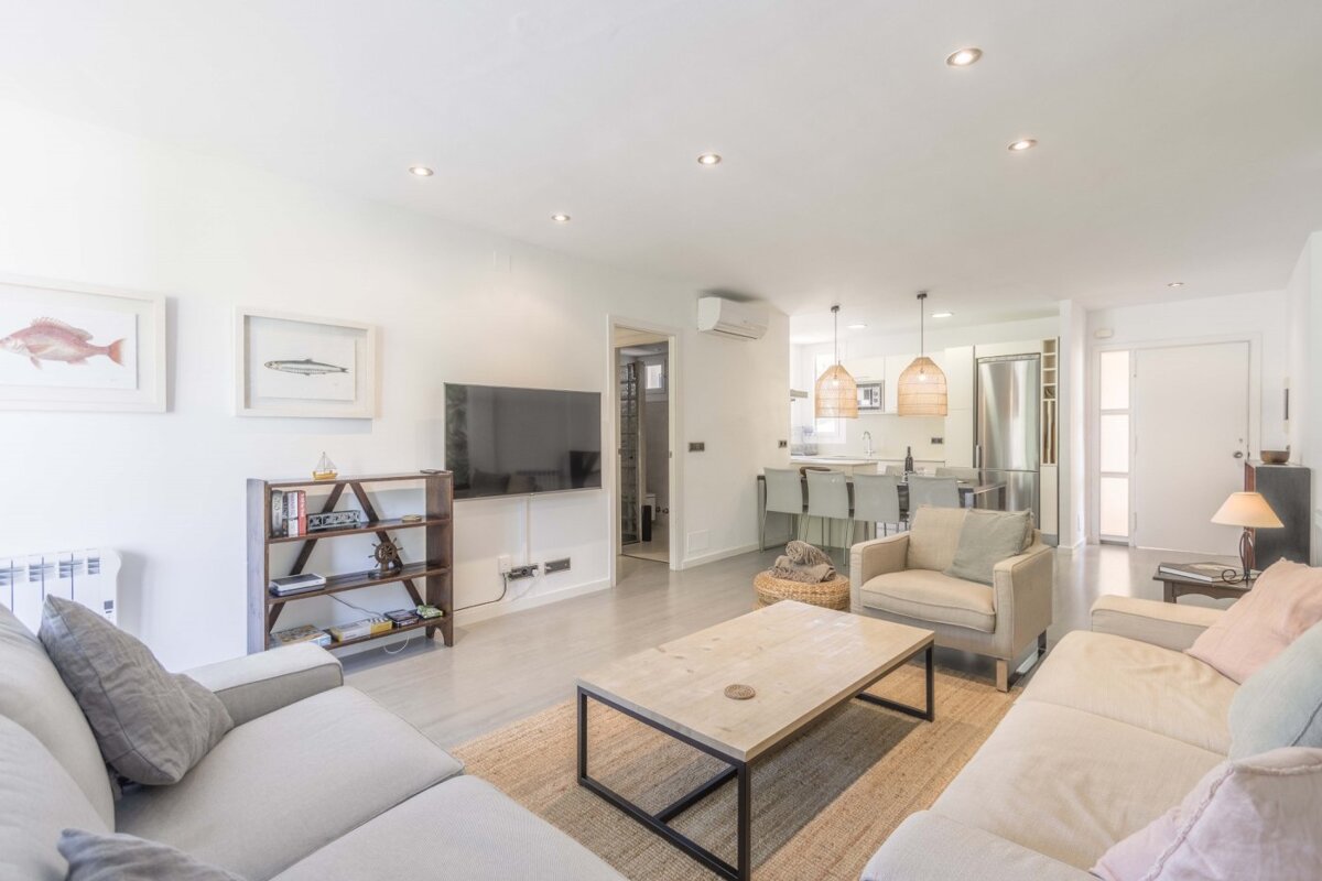 A living room with a couch a chair and a flat screen tv