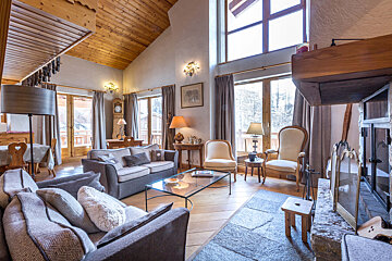 A living room with a couch and chairs and a fireplace