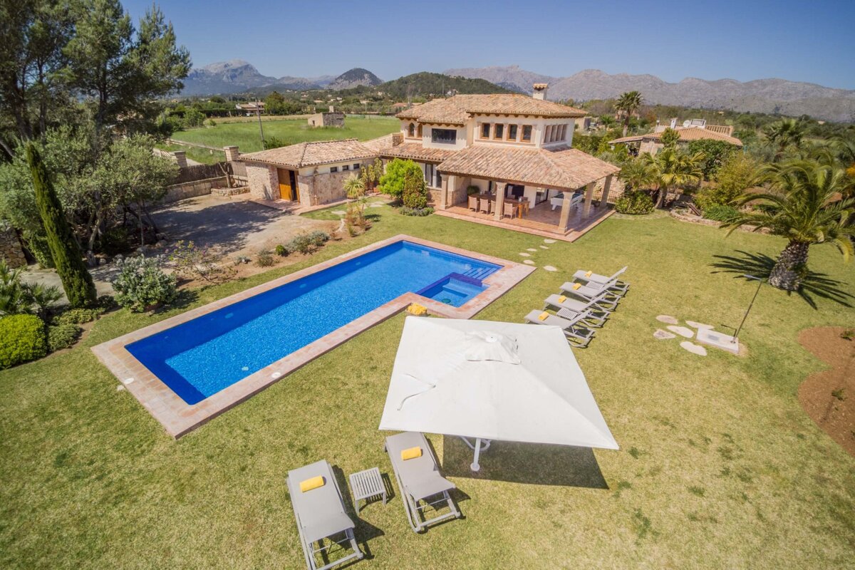 A large house with a large swimming pool in front of it