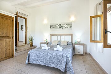 A bedroom with a large bed and two nightstands