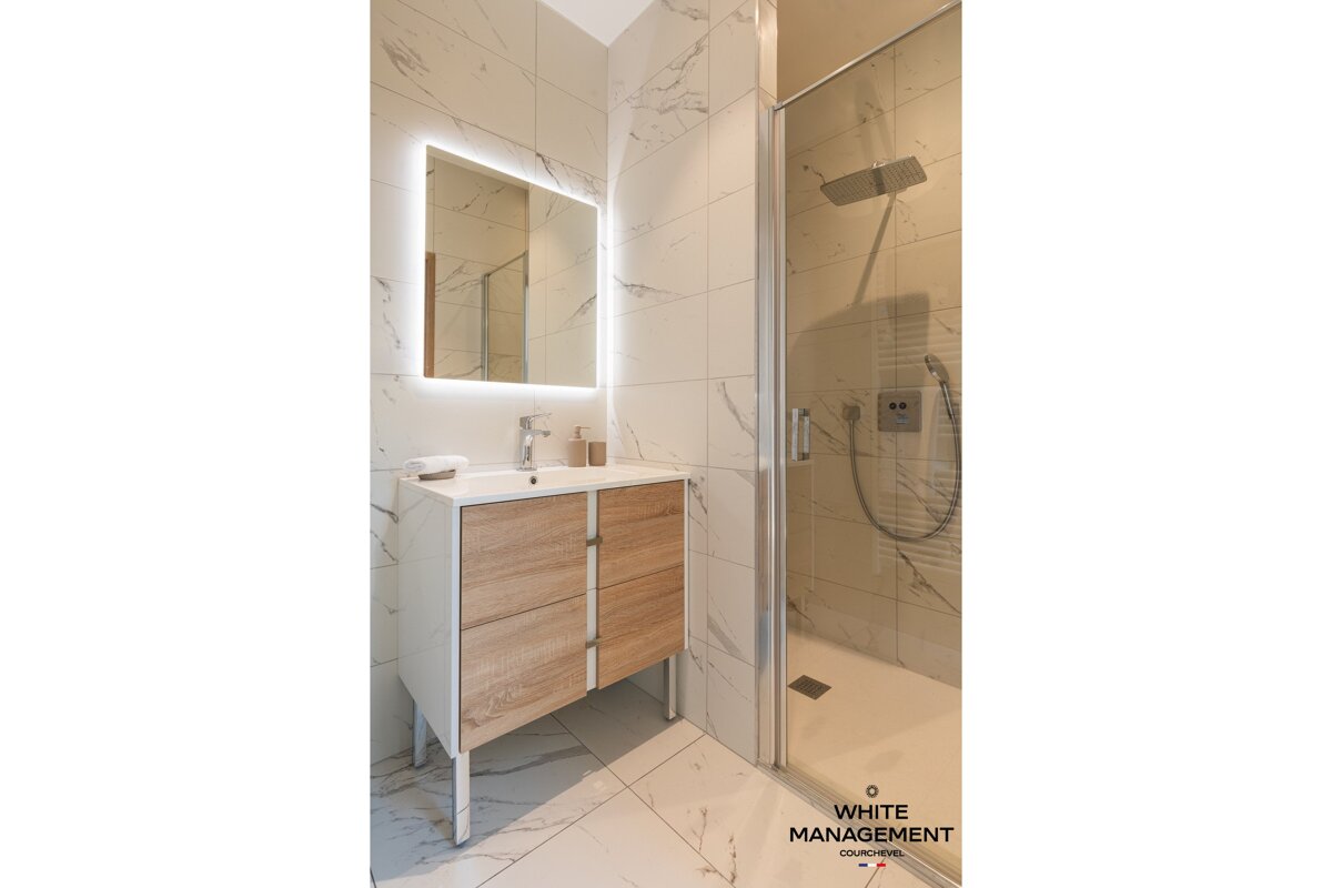 A bathroom with white management written on the bottom