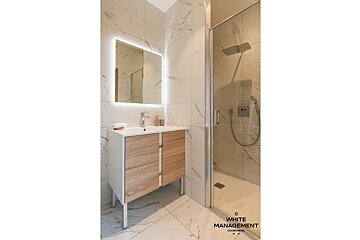 A bathroom with white management written on the bottom