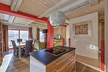 A kitchen with a stove top oven and a picture on the wall