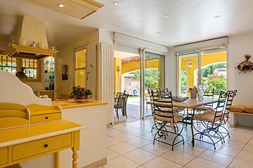 A dining room with a table and chairs and a sliding glass door