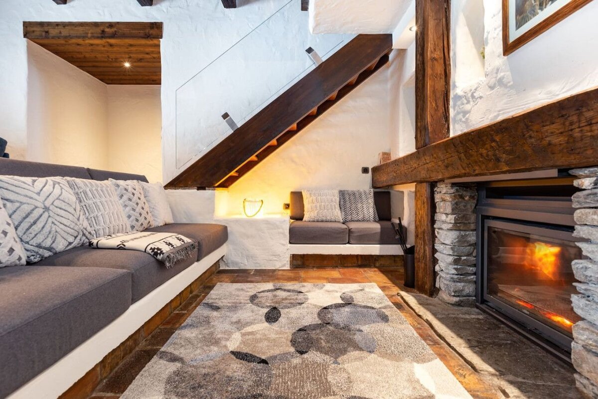 A living room with a fireplace and stairs