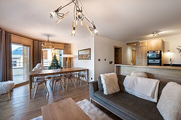 A living room with a couch and a dining table
