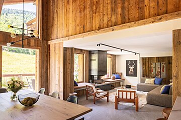 A living room with a deer painting on the wall