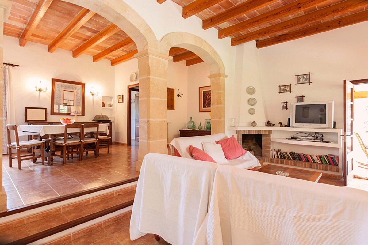 A living room with a fireplace and a flat screen tv