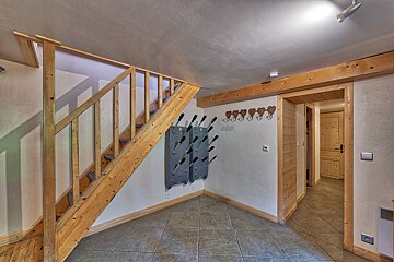 A wooden staircase leading up to the second floor