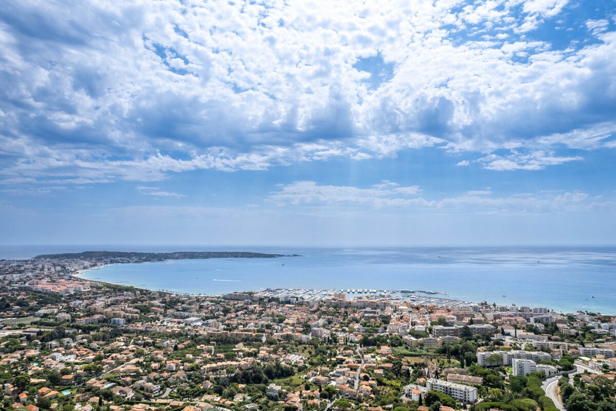 An aerial view of a city with a large body of water in the background