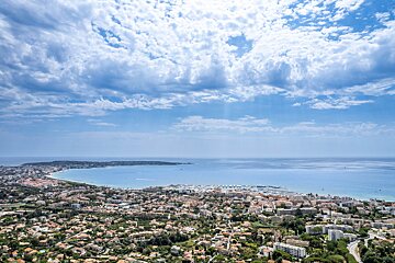 An aerial view of a city with a large body of water in the background