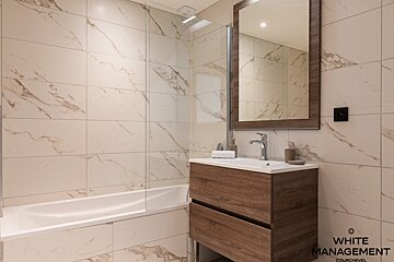 A living room with a couch a chair and a television