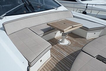 A boat with a wooden table on the deck