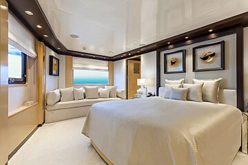 A bedroom with a large bed and a couch