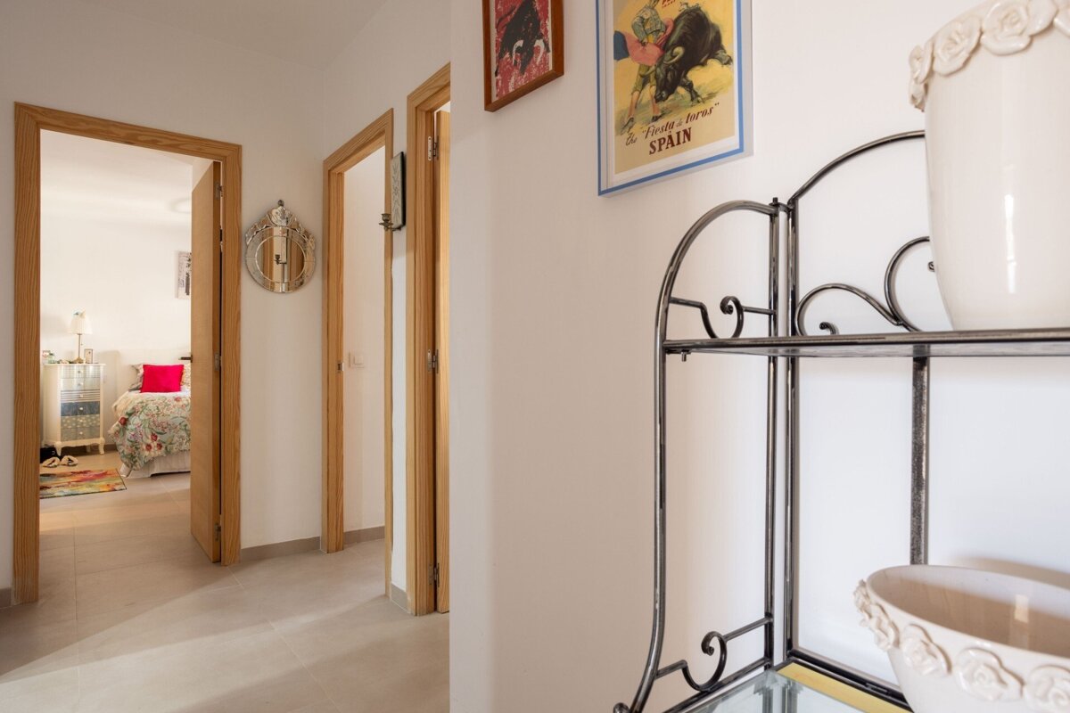 A hallway with a poster on the wall that says spain