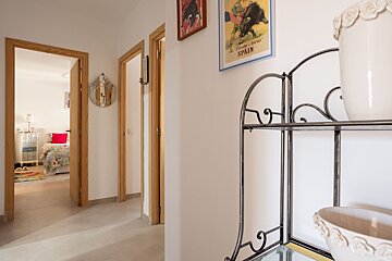 A hallway with a poster on the wall that says spain