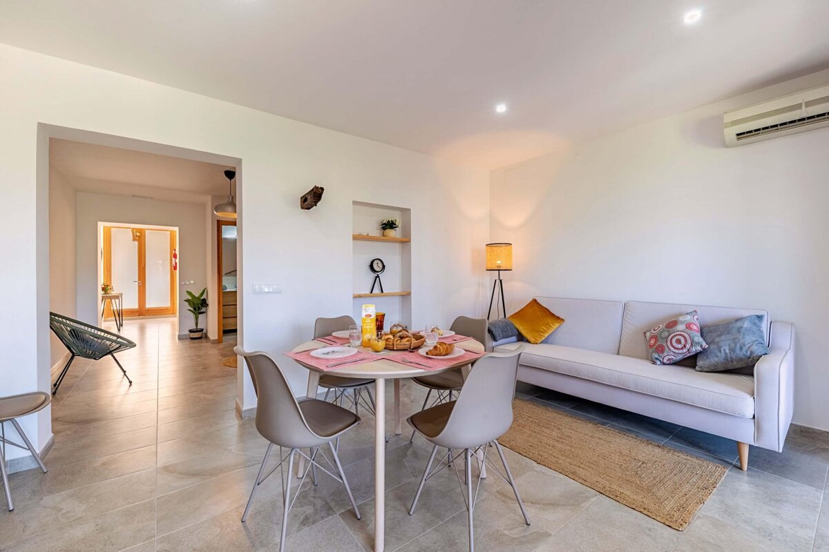 A living room with a table and chairs and a couch