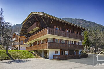 A large house with a sign that says alpine property