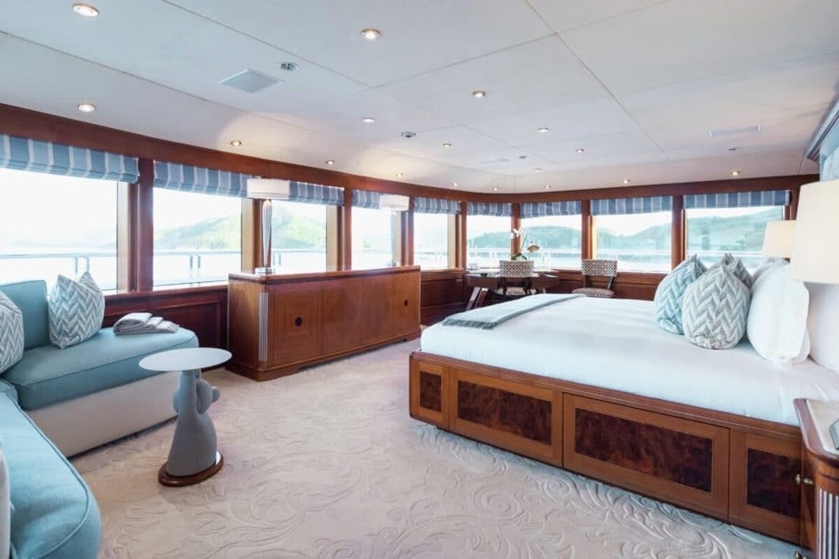 A bedroom with a large bed and a couch