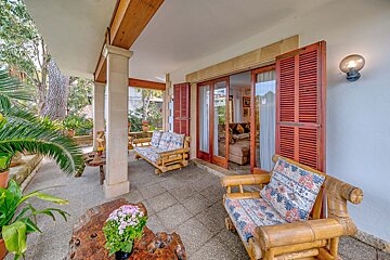 A patio with a couch and chairs and a table