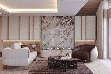 Luxurious living room with a marble fireplace, modern white sofa, brown armchair, and dark marble coffee table. Warm, chic interior design.